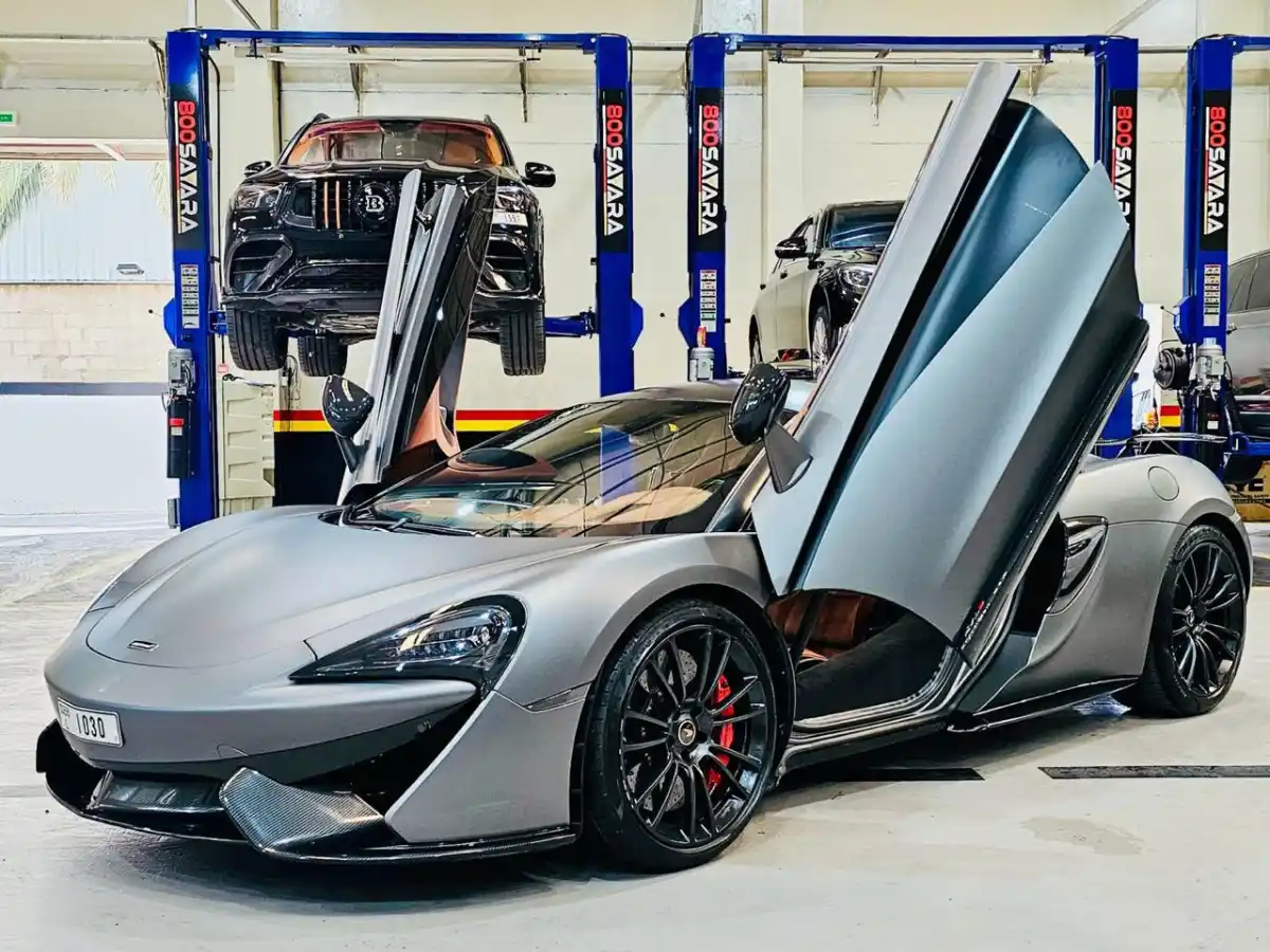 Wide view of the 800Sayara workshop bays with cars on lifts